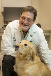 Dr. Rodney Page with a golden retriever