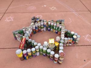 Members of Hillel, the Jewish fraternity on campus, made a star of David with their cans. The event is part of the annual Cans Around the Oval food drive for the Larimer Food Bank.