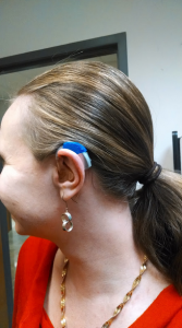 Megan Aanstoos tests out her 3D printed hearing aid cover