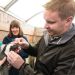 CSU veterinarian evaluates Tess the penguin as her handler holds her