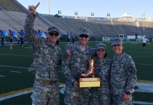Caitlin Lozano and cadets holding the Bronze Boot at Hughes Stadium
