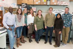 Elizabeth Ryan with her research group standing in a laboratory