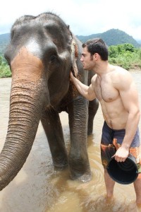 Evan Antin in the water with an Asiatic elephant in Thailand