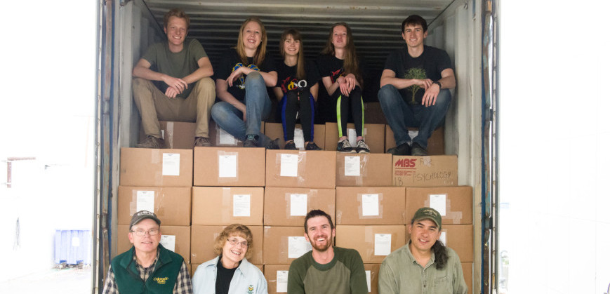 Bob and Nancy Sturtevant (front row left), Ecology Ph.D. student Matt Luizza, and NREL research scientist Paul Evangelista take a break with volunteers from Alpha Phi Omega before they finish filling the shipping container with books for Hawassa University.