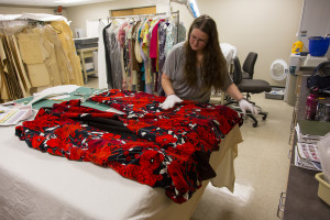 Avenir graduate assistant Caitlin MacLaughlin works on a Richard Blackwell garment.