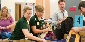 Colorado State University School Is Cool volunteers stuff backpacks with school supplies for Poudre School District students. August 6, 2014.