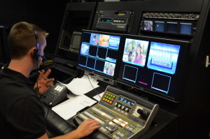 Zach Newton, former Campus Television student manager, directs a live television program from the CSU studios in the Clark Building.
