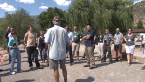 Jim Pokrandt, community relation director of the Colorado River District, talks with members of the Rams in the Rockies Tour along the banks of the Colorado River in Glenwood, Springs.