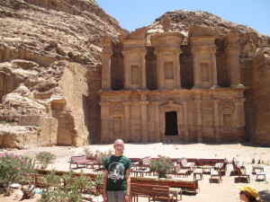 student posing in front of sand carved ancient temple