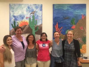 Kim Kita (second from left) with colleagues Amy Rex, Aines Castro, Tania Zenteno-Savin, McKenzie Campbell, and Danielle Straatmann (left to right) at a community event in May, 2016. The artwork was created by CSU Fish, Wildlife and Conservation Biology students and local grade school students.
