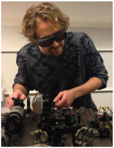 Zak Burkley works with ultraviolet lasers for cooling hydrogen.
