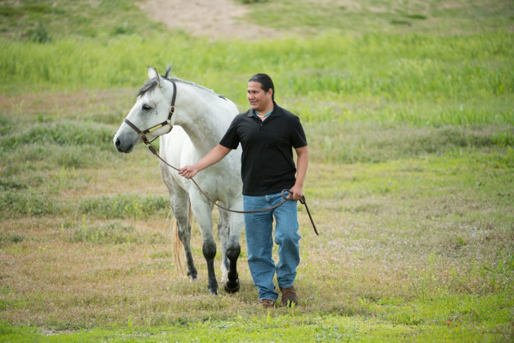 Patrick Succo, a second year DVM student, with "Blue" a CSU horse at CSU's Equine Center. May 27, 2016