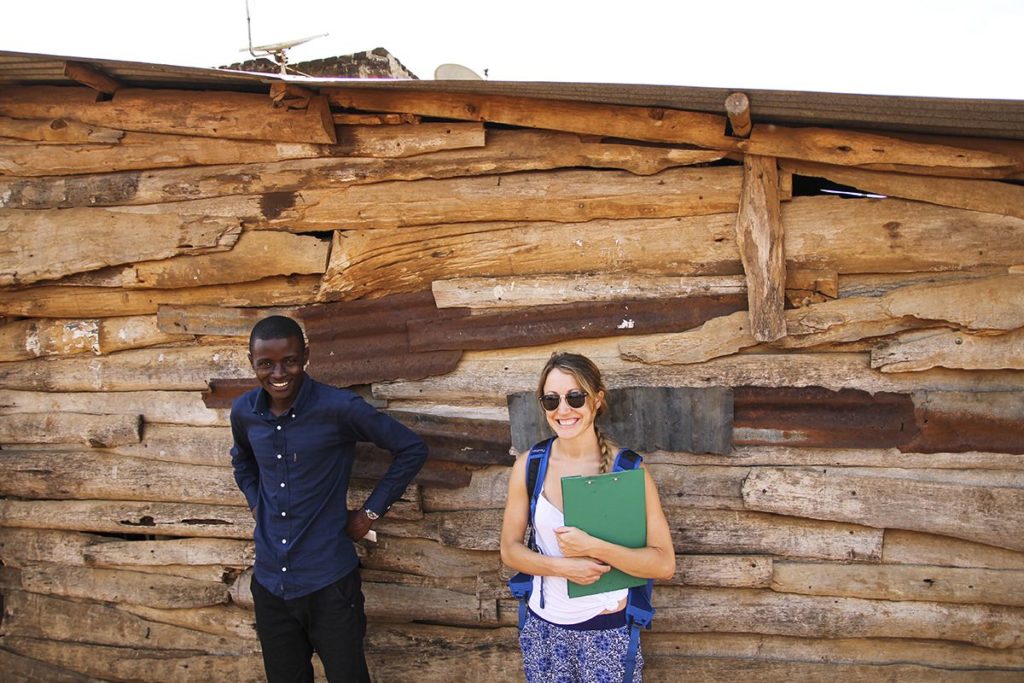 Alyse Daunis stands next to the GSSE group's driver, Hashim Mutanje, in a village near Jinja, Uganda. Alyse worked with Hashim at the start-up social enterprise LiTeAfrica when she lived in Uganda for a year.