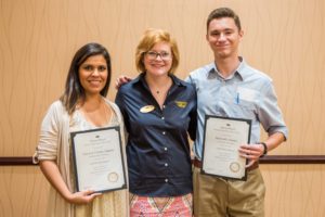 Colorado State University chapter President Liz Hicks, left, and University of Montana chapter Vice President Matthew Thomas, right, received a Mortar Board Gold Torch from section coordinator Kelsey Willis.