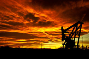A pump jack at sunset. Image by Justin Vidamo.