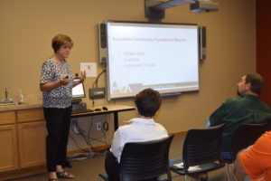 Cindy Horner, left, of ECCF Board of Directors makes a presentation at the Northeast Regional Engagement Center. 