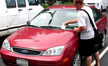 A parking citation on a car windshield