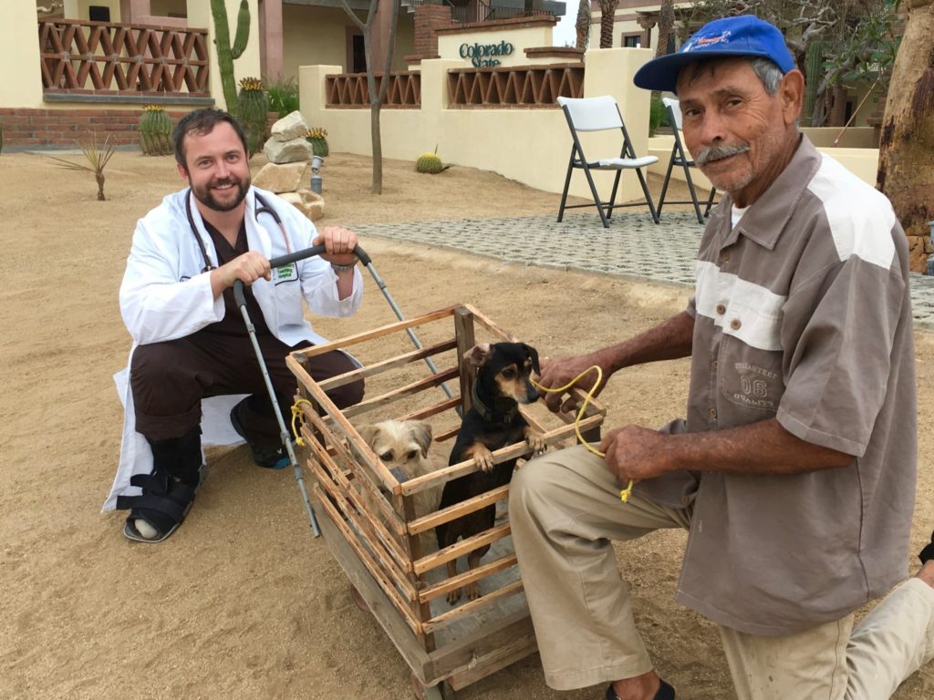 Dr. Cody Minor assists a man with his dogs at the CSU Todos Santos Center in Baja California Sur. “Cody helped to change the way people think about their animals,” said Amy Rex, a Todos Santos native who works at the center.