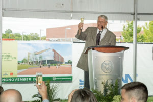 color photo of John Malone, giving a toast at groundbreaking event