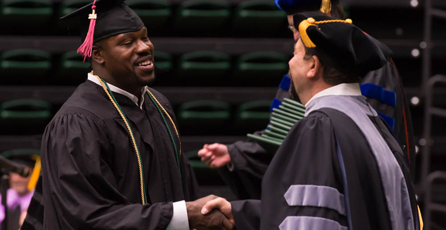 Joey Porter celebrates his graduation at the Colorado State University College of Liberal Arts Commencement, May 17, 2014.