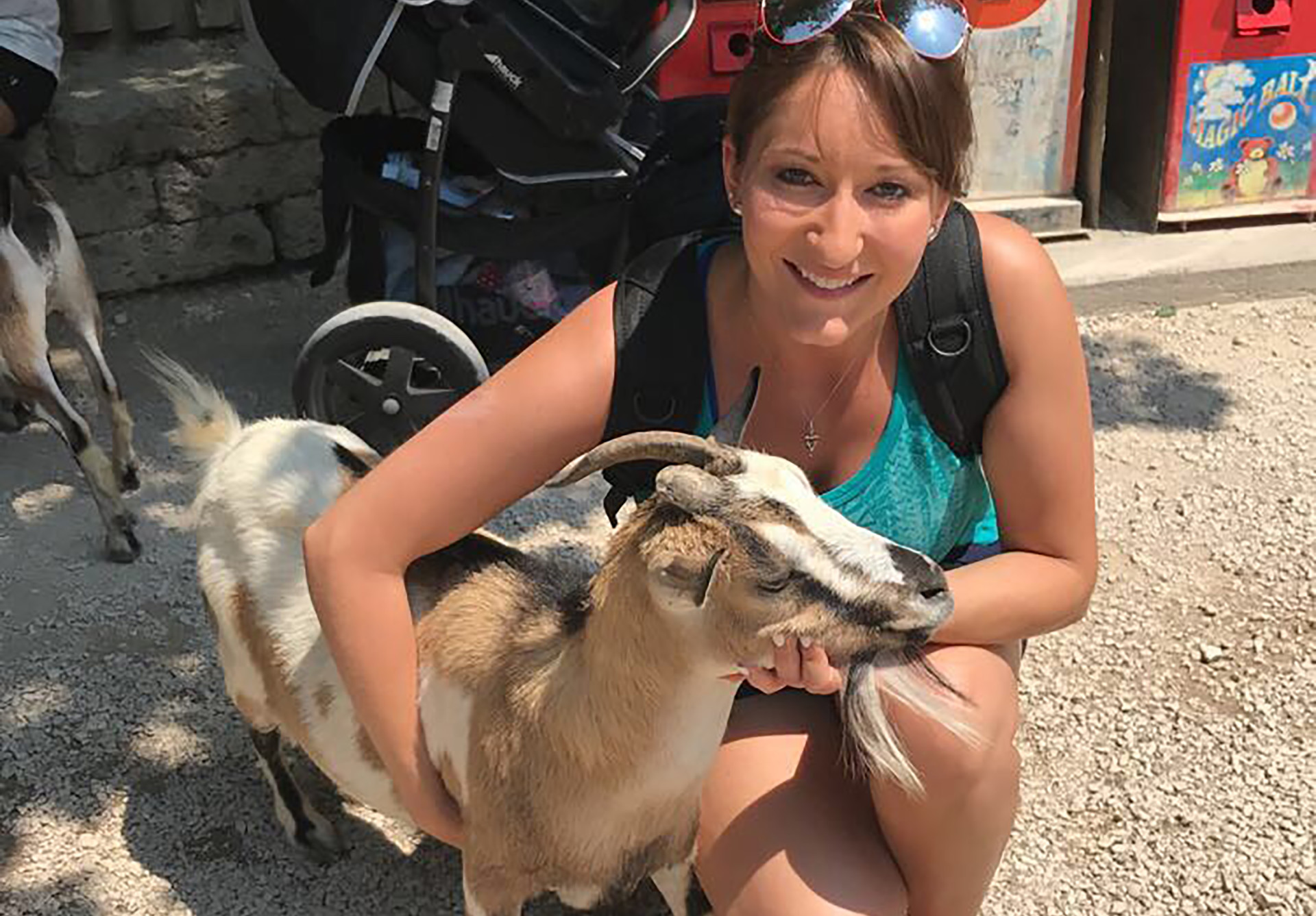 Malinda DeBell posing with a goat in Italy