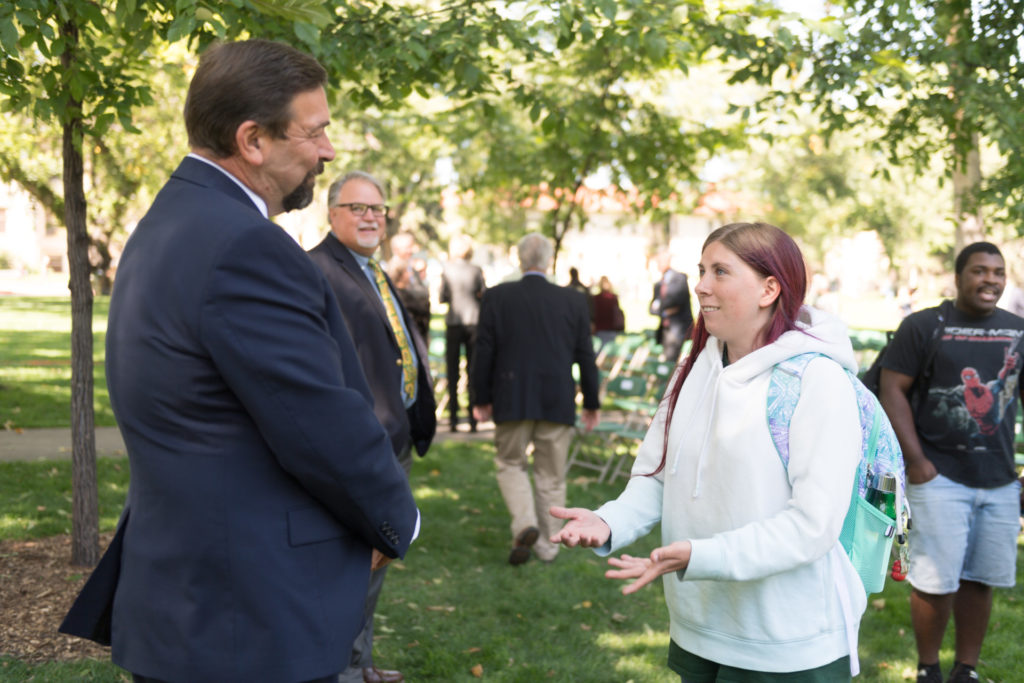 color photo of CSU President Tony Frank talking with a community member