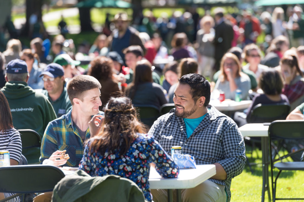 color photo of people eating a picnic lunch on the Oval