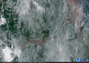 color photo of a satellite image above the Amazon, showing clouds