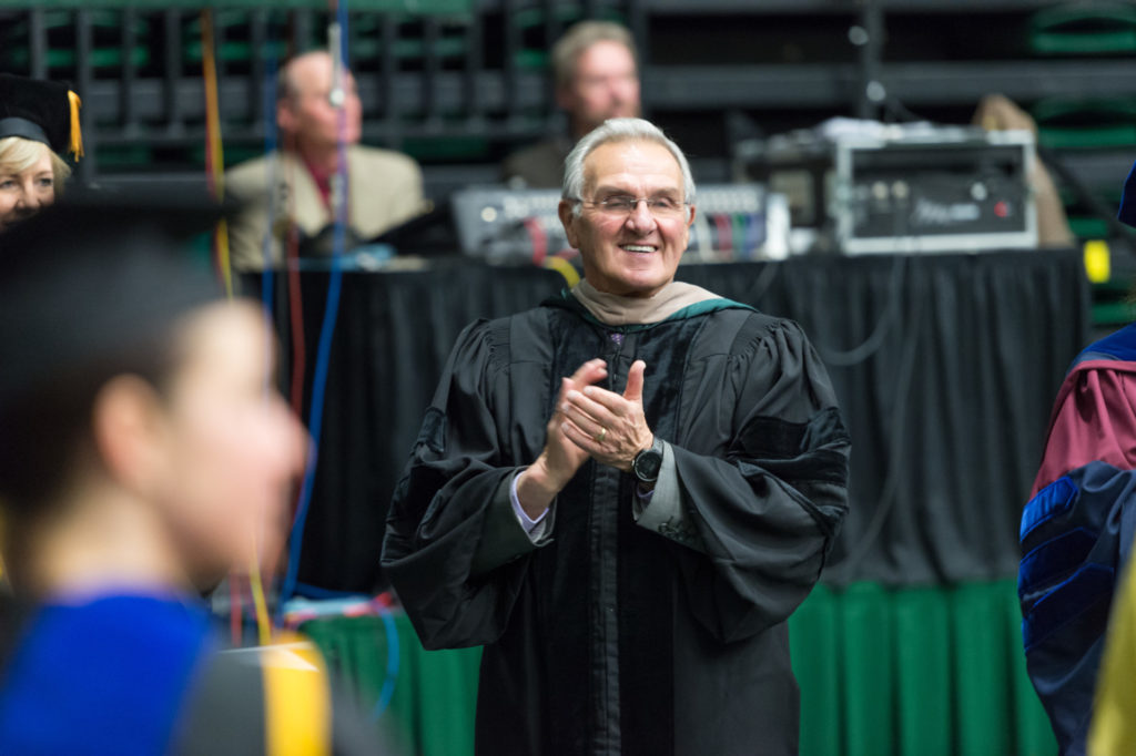 Sonny Lubick applauds College of Business graduates