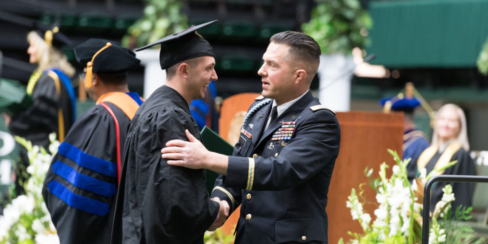 ROTC graduate congratulated by Army officer