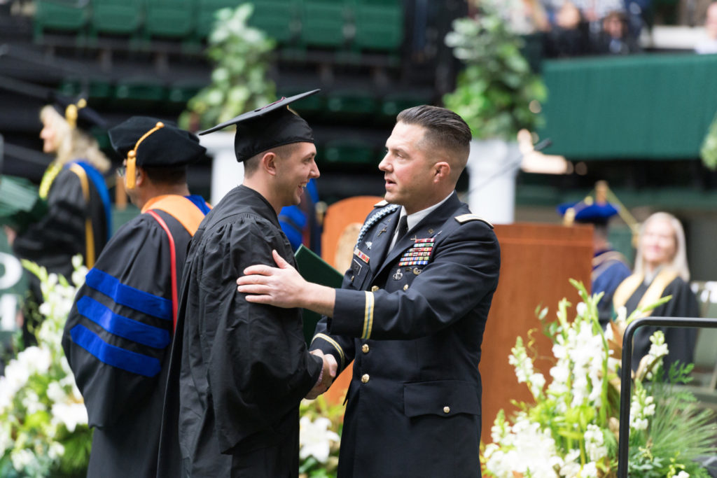 ROTC graduate congratulated by Army officer