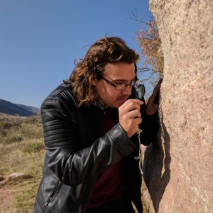 Dalton Meyer examines rock face