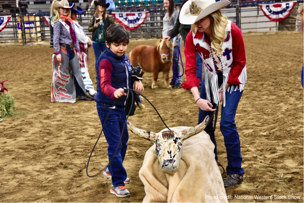 Exceptional Rodeo participant roping a fake bull prop.