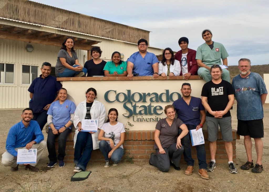 Group photo of fish pathology workshop participants in front of CSU Todos Santos sign.