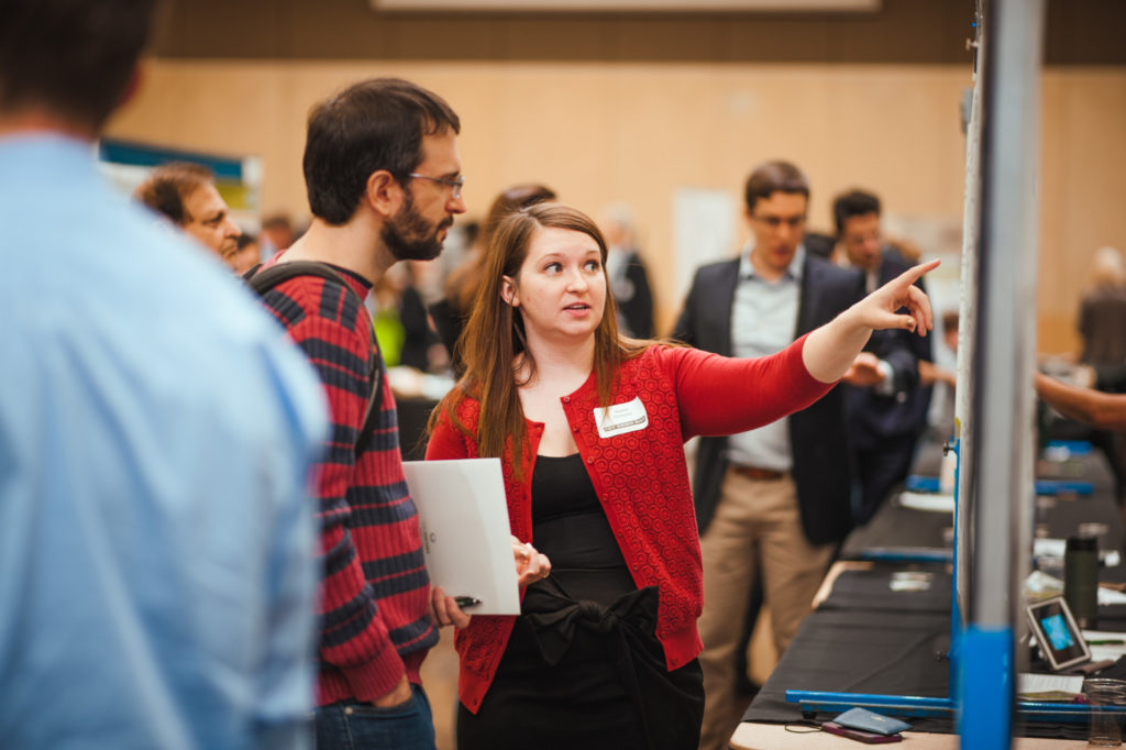 Student explains her poster at Demo Day 2018