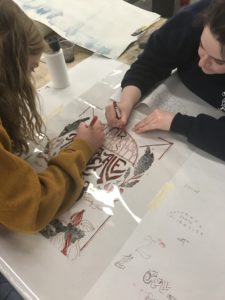 students working on poster design