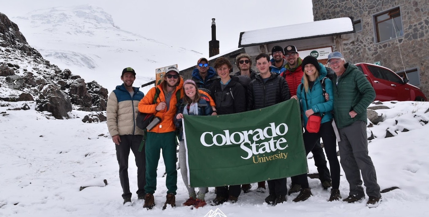 PEOPLE IN SNOW WITH COLORADO STATE BANNER