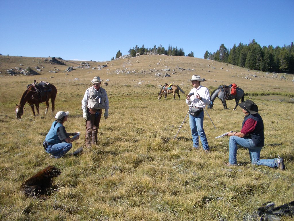 Ranchers out on land with horses