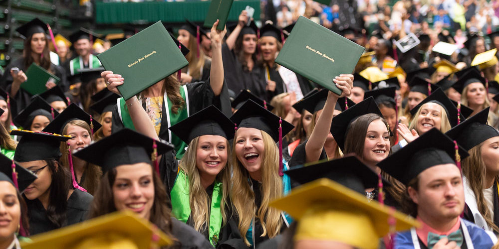 Grads hold up diplomas