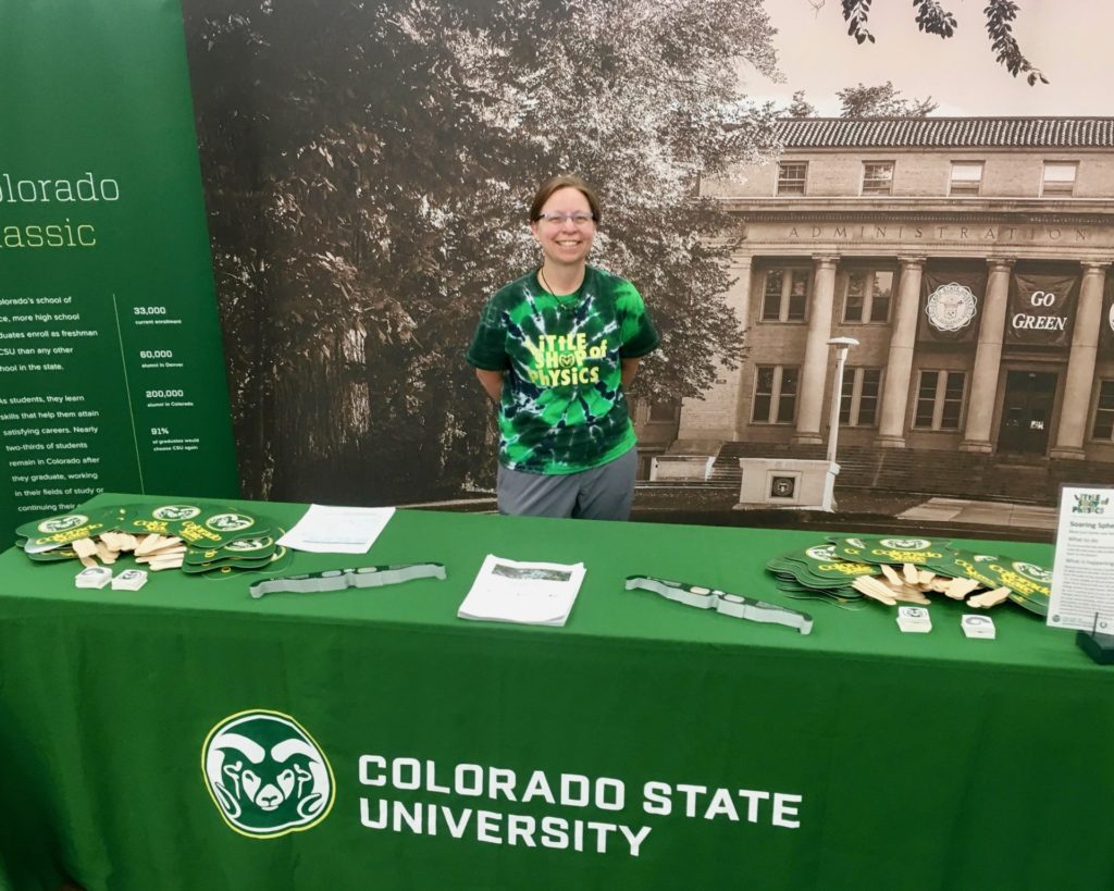 Heather Michalak, assistant director of CSU Little Shop of Physics, smiles at CSU's booth at the 2018 Denver County Fair.