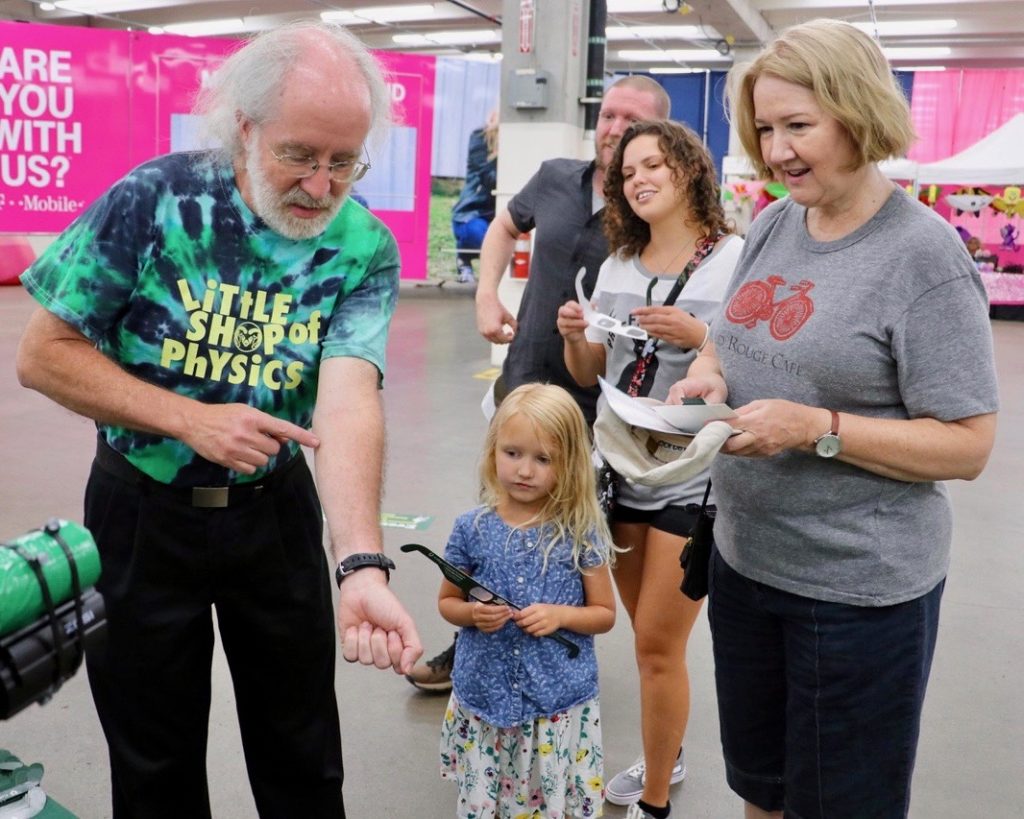 Brian Jones, director of CSU Little Shop of Physics, walks attendees through science experiment at CSU's booth at the 2018 Denver County Fair.