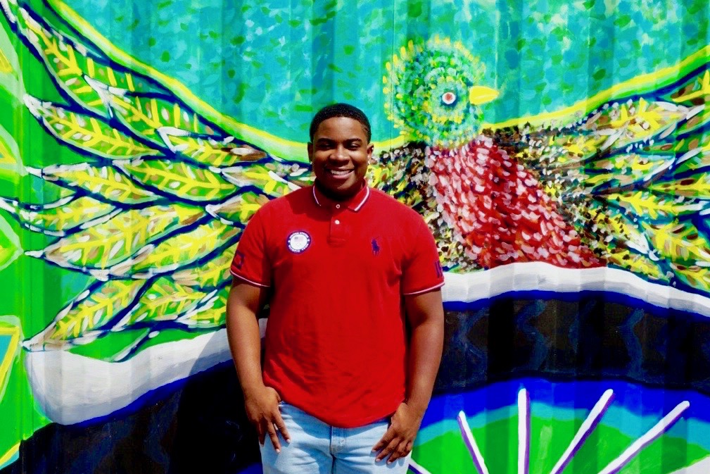 Malachi Haynes, winner of the Boys & Girls Clubs of Metro Denver's Youth of the Year Award standing in front of street art in Denver.