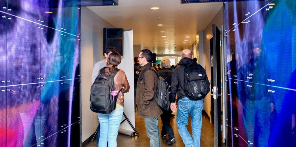 Denver Startup Week attendees walk through light-up hallway at Basecamp, located at The Commons on Champa.