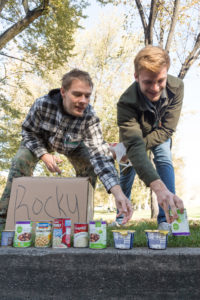 Students placing cans