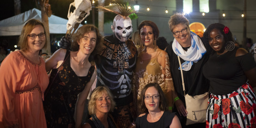Participants of the 2018 Spanish & Culture Immersion Course pose with local dressed in traditional Dia de Muertos attire during celebration.