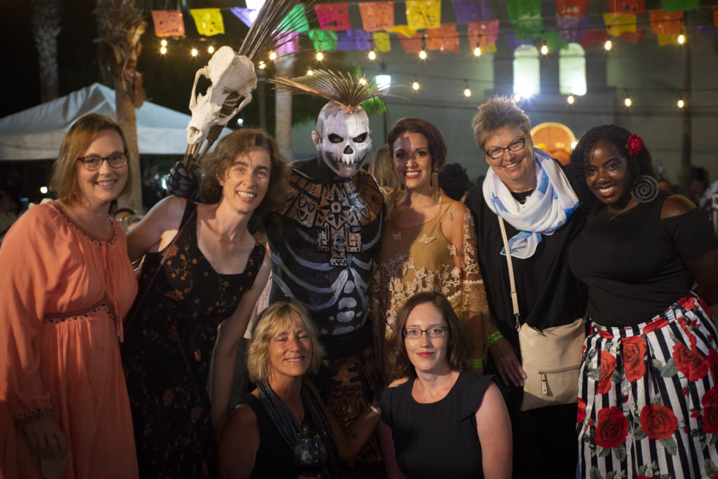 Participants of the 2018 Spanish & Culture Immersion Course pose with local dressed in traditional Dia de Muertos attire during celebration.