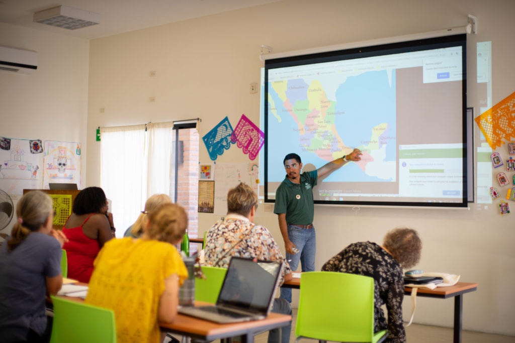 Olaf Morales, languages instructor, points out location on projected map during 2018 Spanish & Culture Immersion Program at the CSU Todos Santos Center.