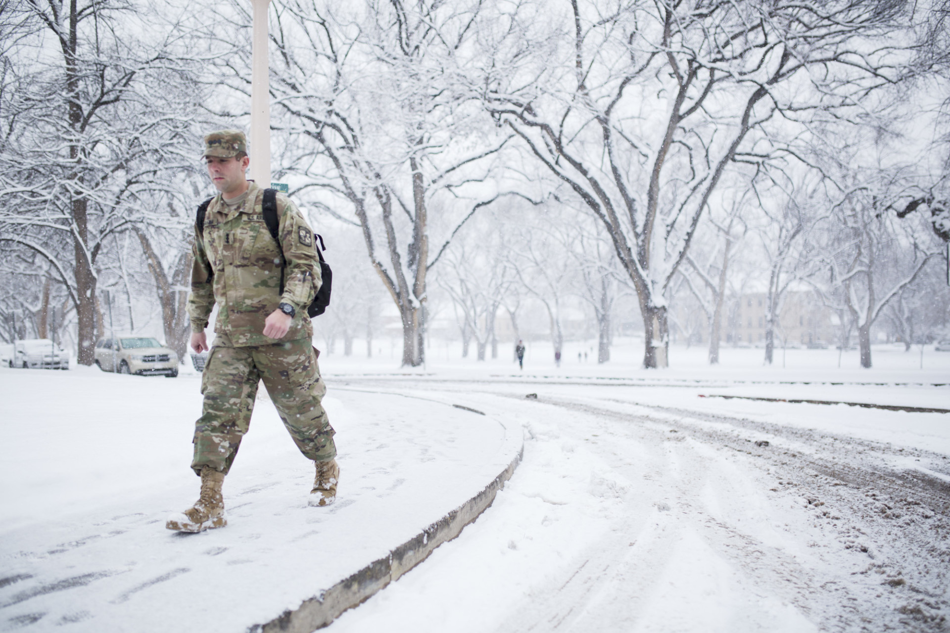 Student in fatigues on snowy Oval