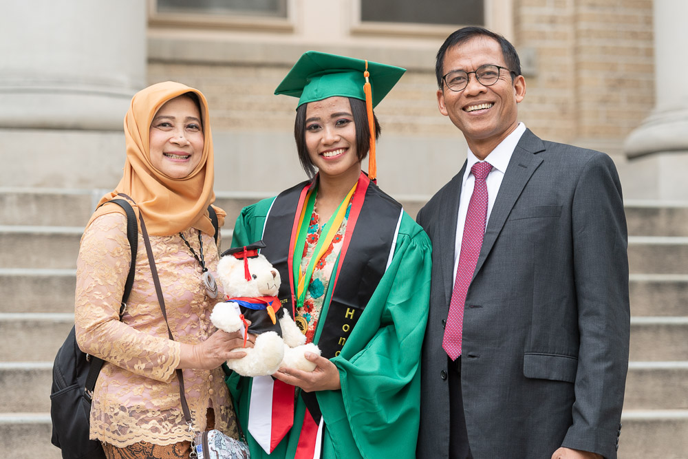 Family with Honors graduate in front of Admin building