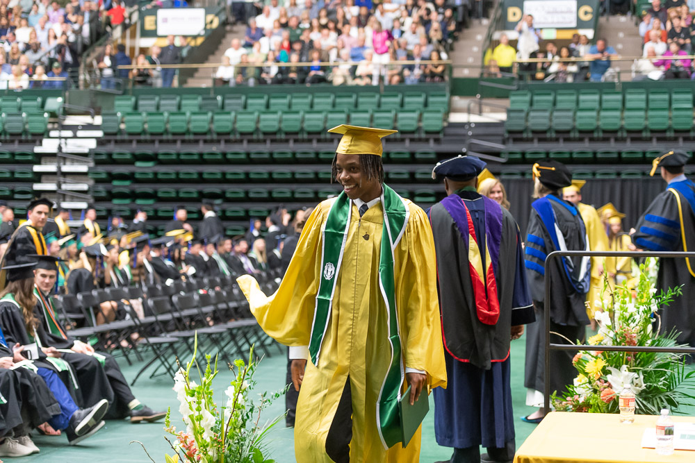 Graduates walking across the stage in Moby Arena